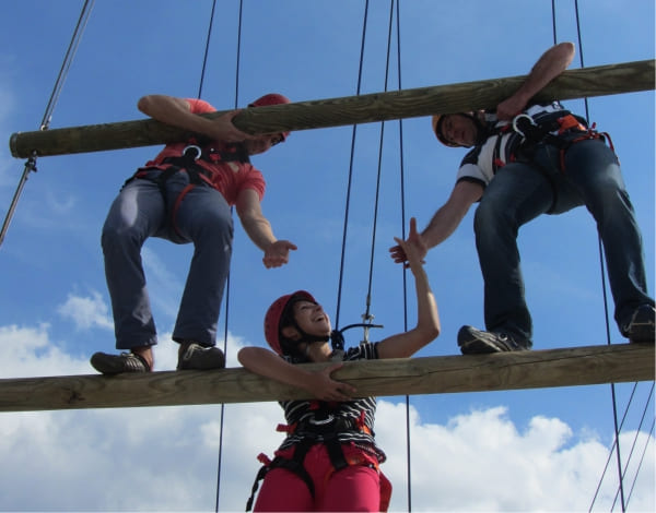 Drei junge Teilnehmer helfen sich bei der Bew�ltigung eines Kletterelements